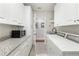 Laundry room with washer, dryer, and granite countertop at 1010 Grouse Way, Venice, FL 34285