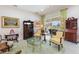 Living room with French doors opening to a pool and patio area at 1010 Grouse Way, Venice, FL 34285