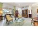 Living room with French doors opening to a pool and patio area at 1010 Grouse Way, Venice, FL 34285