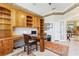 Home office with built-in wooden cabinets and a large desk at 1010 Grouse Way, Venice, FL 34285