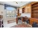 Home office with built-in wooden cabinets and a large desk at 1010 Grouse Way, Venice, FL 34285