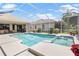 Inviting pool area with screened enclosure, spa, and lush landscaping at 1010 Grouse Way, Venice, FL 34285