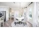 Bright dining area with elegant chairs, chandelier, and view to the kitchen and stainless steel refrigerator at 10382 Coquina Ct, Placida, FL 33946