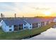 Aerial view of condo community at sunset with water views at 1100 Capri Isles Blvd # 317, Venice, FL 34292