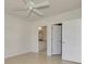Bedroom with ceiling fan, private bathroom access, and walk-in closet at 1102 Auburn Cove Cir, Venice, FL 34292