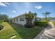 Exterior view of a single-story villa showcasing its side profile and landscaping at 1102 Auburn Cove Cir, Venice, FL 34292