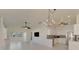 Open concept kitchen and living area with white cabinets, granite counters, and tile floors at 1102 Auburn Cove Cir, Venice, FL 34292
