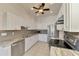 Modern kitchen features granite countertops, stainless steel appliances, and white cabinets at 1102 Auburn Cove Cir, Venice, FL 34292