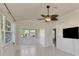 Bright living room with tile floors, ceiling fan, and large windows at 1102 Auburn Cove Cir, Venice, FL 34292