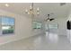 Bright living room with tile flooring, ceiling fan, and access to a sunroom at 1102 Auburn Cove Cir, Venice, FL 34292