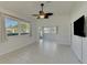 Spacious living room with tile floors, large windows, and sliding glass doors at 1102 Auburn Cove Cir, Venice, FL 34292