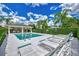 Community pool with lounge chairs and covered seating area at 1102 Auburn Cove Cir, Venice, FL 34292