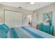 Bright bedroom features a large closet, pelican decor, and beachy accents at 1106 Bird Bay Way # 316, Venice, FL 34285
