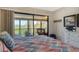 Bright bedroom offers ample natural light and sliding glass doors to a screened lanai at 1106 Bird Bay Way # 316, Venice, FL 34285
