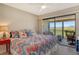 Bright bedroom features a private balcony overlooking lush greenery, with comfortable seating at 1106 Bird Bay Way # 316, Venice, FL 34285
