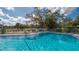 Inviting community pool with lounge chairs at 1106 Bird Bay Way # 316, Venice, FL 34285