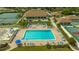 Community pool with lounge chairs, tables, and lush landscaping for relaxing in the Florida sun at 1106 Bird Bay Way # 316, Venice, FL 34285