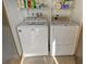 Clean and organized laundry area with modern washer and dryer units, with storage at 1106 Bird Bay Way # 316, Venice, FL 34285