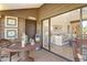 Relaxing patio with wicker furniture and view into living room at 1106 Bird Bay Way # 316, Venice, FL 34285