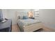 Comfortable bedroom features a white bed frame and tasteful decor at 11140 Hogan Cir, Englewood, FL 34223