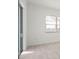 Bright bedroom with wood-look flooring, sliding glass doors, and large window at 11140 Hogan Cir, Englewood, FL 34223