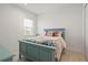 Cozy bedroom with patterned bedding, natural light, and a serene atmosphere at 11140 Hogan Cir, Englewood, FL 34223