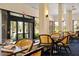 Inviting dining area offering natural light, comfortable seating, and views of the surrounding golf course and greenery at 11140 Hogan Cir, Englewood, FL 34223
