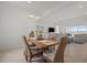 Dining room with a wood table and six chairs, with view to the living room at 11140 Hogan Cir, Englewood, FL 34223