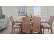 Dining room with wood table, six chairs, and a sailboat painting on the wall at 11140 Hogan Cir, Englewood, FL 34223