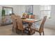 Dining room with a wood table, six chairs, and natural light from the window at 11140 Hogan Cir, Englewood, FL 34223