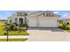 Beautiful two-story home featuring a three-car garage and lush landscaping at 11140 Hogan Cir, Englewood, FL 34223