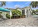 Exterior view showcasing patio, outdoor seating, pool area, landscaping, and building architecture at 11140 Hogan Cir, Englewood, FL 34223