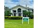 Well-maintained home with manicured lawn, lush landscaping, and 'The Resort' signage on display at 11140 Hogan Cir, Englewood, FL 34223