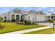 Inviting home with a manicured lawn, a paved driveway and a two car garage at 11140 Hogan Cir, Englewood, FL 34223