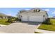 A stunning home features a paved driveway leading to a spacious two-car garage at 11140 Hogan Cir, Englewood, FL 34223