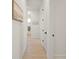Hallway with a painting on the wall and doors, with the view into the bathroom at the end at 11140 Hogan Cir, Englewood, FL 34223
