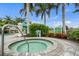 Inviting hot tub surrounded by lush landscaping and palm trees offers a relaxing outdoor amenity at 11140 Hogan Cir, Englewood, FL 34223