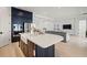 Modern kitchen with island, stainless steel appliances and white countertops overlooking the dining and living area at 11140 Hogan Cir, Englewood, FL 34223