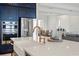 Modern kitchen with island, stainless steel appliances and white countertops overlooking the dining and living area at 11140 Hogan Cir, Englewood, FL 34223