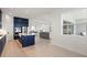 Open-concept kitchen featuring navy cabinetry, stainless steel appliances, and a large island with white countertop at 11140 Hogan Cir, Englewood, FL 34223