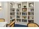 Cozy library featuring built-in bookshelves, a variety of books, and a quiet space for reading and relaxation at 11140 Hogan Cir, Englewood, FL 34223