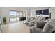 An open living room and kitchen area with a view of a screened in pool at 11140 Hogan Cir, Englewood, FL 34223
