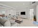 Bright living room showcasing an L-shaped sofa and view into dining area at 11140 Hogan Cir, Englewood, FL 34223