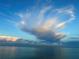Calm ocean view showing clouds in the sky and water reflections at 11140 Hogan Cir, Englewood, FL 34223