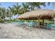 Charming outdoor tiki bar features ample seating and tropical ambiance for relaxation at 11140 Hogan Cir, Englewood, FL 34223