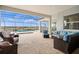 Spacious outdoor patio with comfortable seating and view of pool and landscaping at 11140 Hogan Cir, Englewood, FL 34223