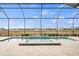 Screened-in pool area with a large pool and views of the surrounding community at 11140 Hogan Cir, Englewood, FL 34223