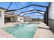 Large screened-in pool with attached spa and ample patio space at 11140 Hogan Cir, Englewood, FL 34223