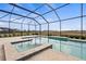 Screened-in pool and spa featuring open views and a spacious patio area at 11140 Hogan Cir, Englewood, FL 34223