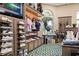 Upscale pro shop featuring golf apparel, shoes, and equipment, with a view of the outdoors through an arched window at 11140 Hogan Cir, Englewood, FL 34223